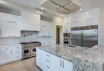 Modern kitchen remodel in Reseda featuring custom wood cabinets and blue accent walls with dual islands